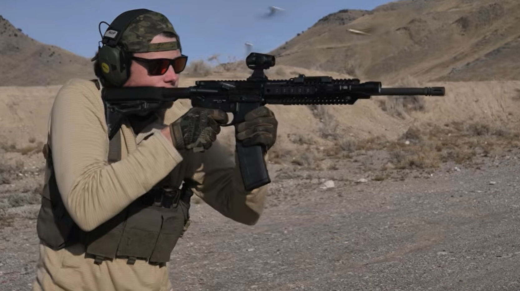 Shooter firing AR-15 rifle at range