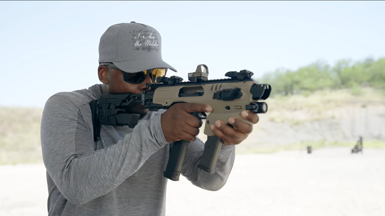 Shooter aiming Glock in MCK chassis