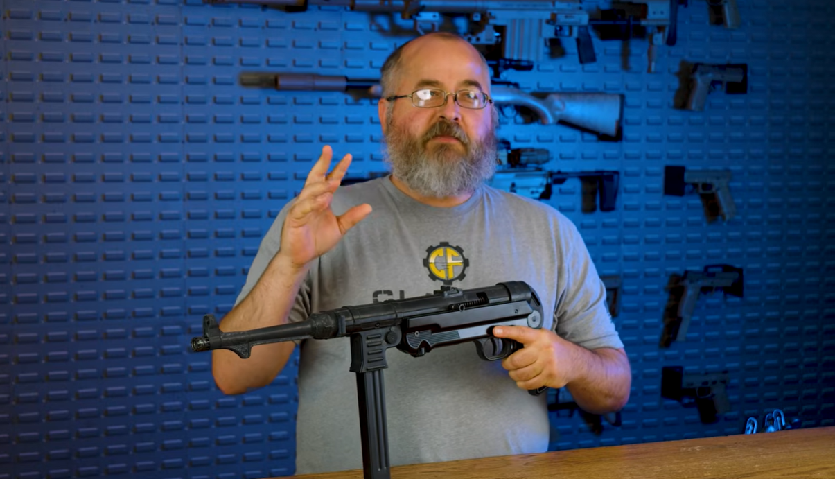 Classic Firearms host holding MP40 pistol