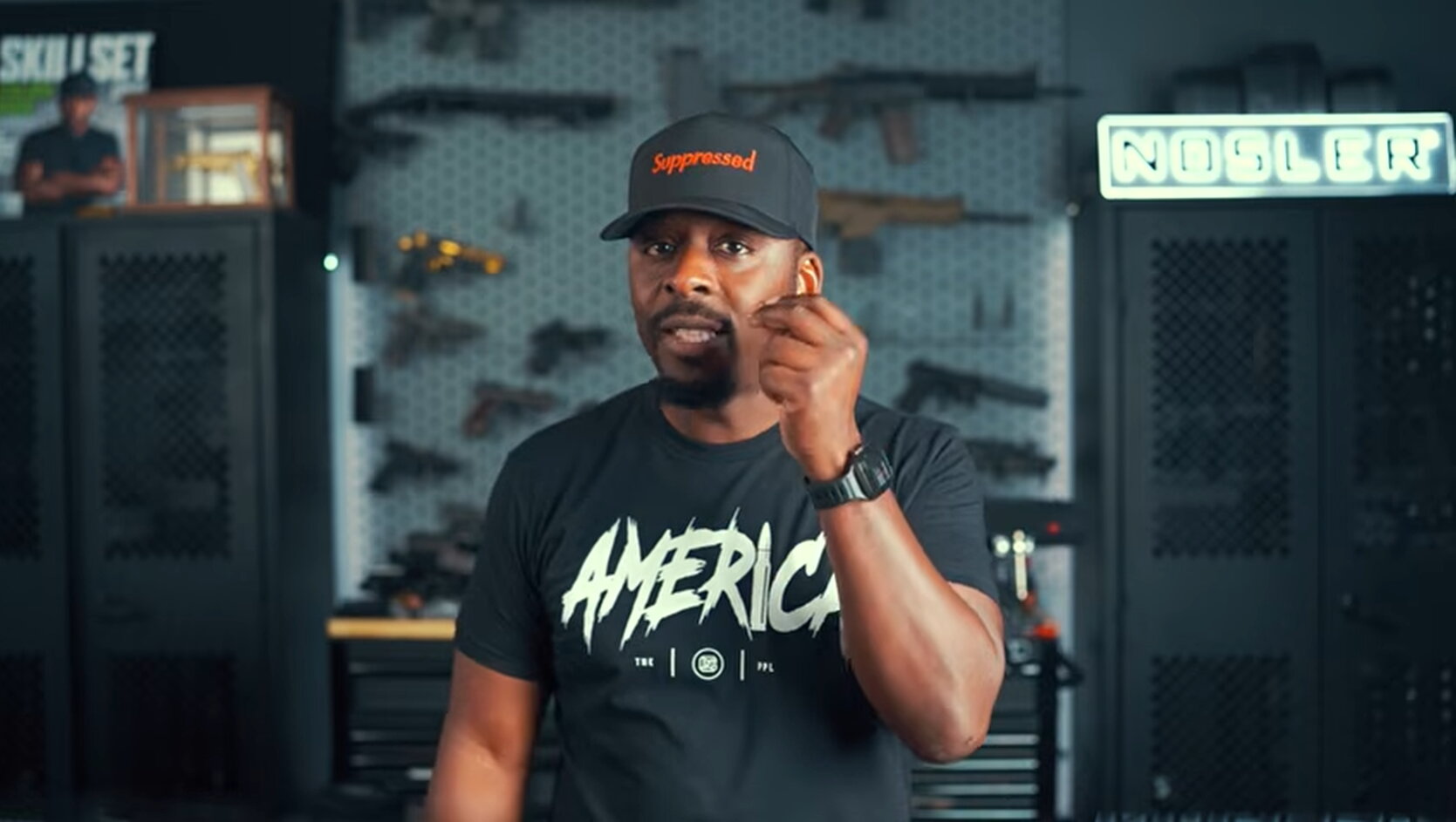 Colion Noir gestures toward his earpiece