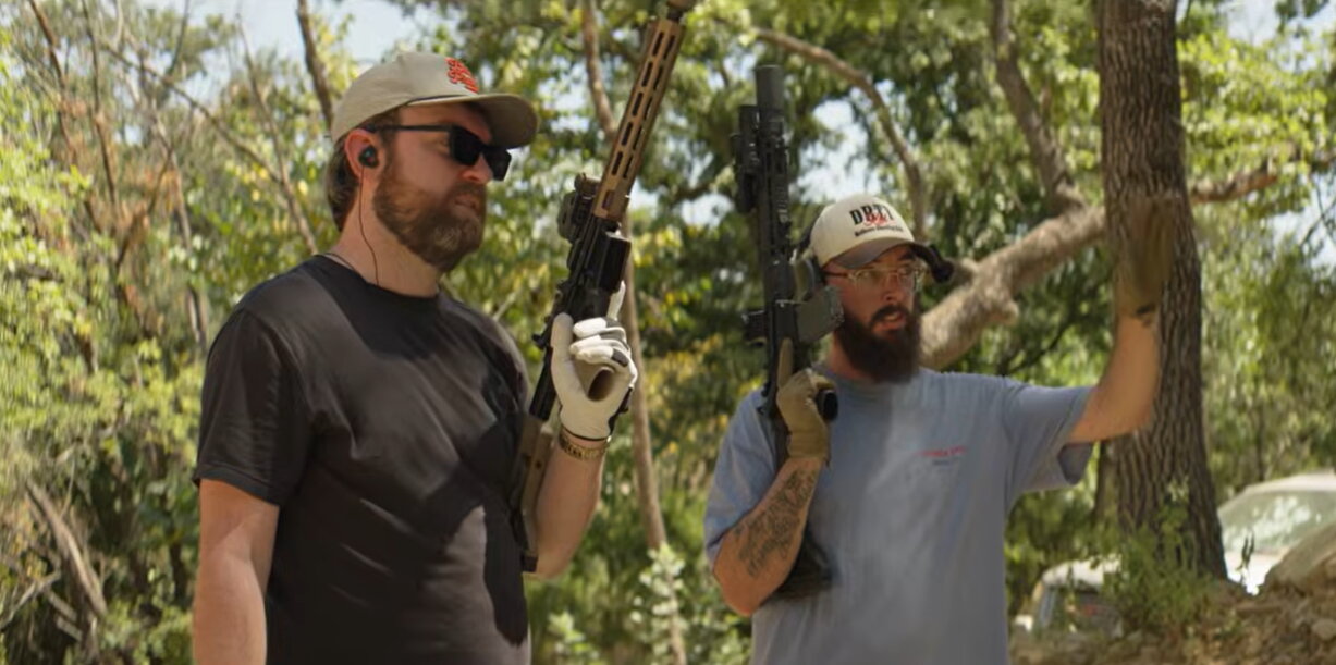 Two shooters holding FRT rifles outdoors