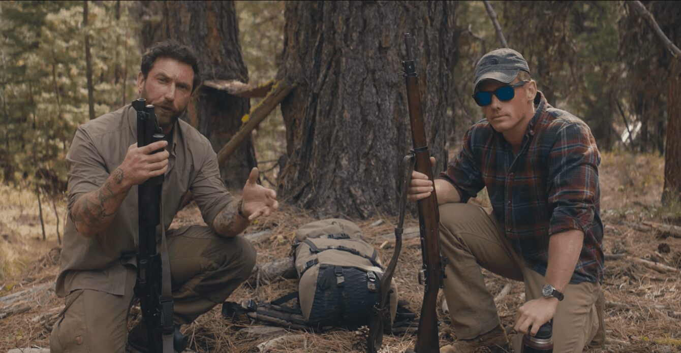 Garand Thumb hosts kneeling in forest