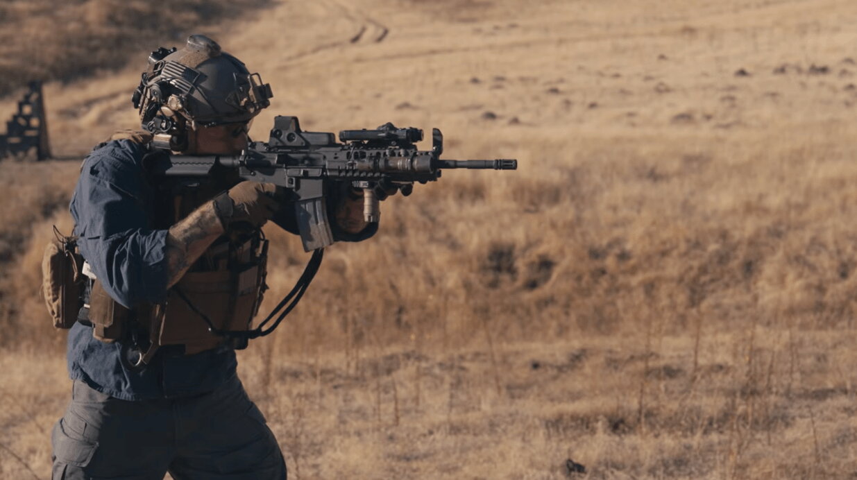 Shooter firing M4 carbine at range