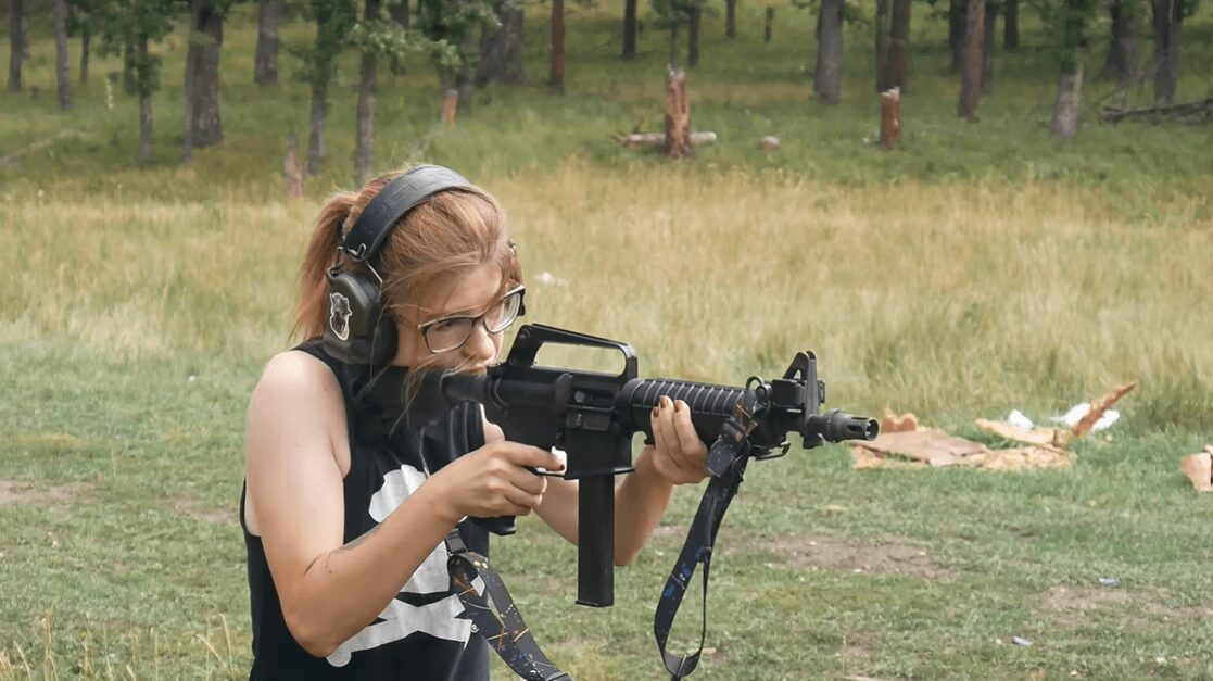 Shooter firing 9mm carbine at range