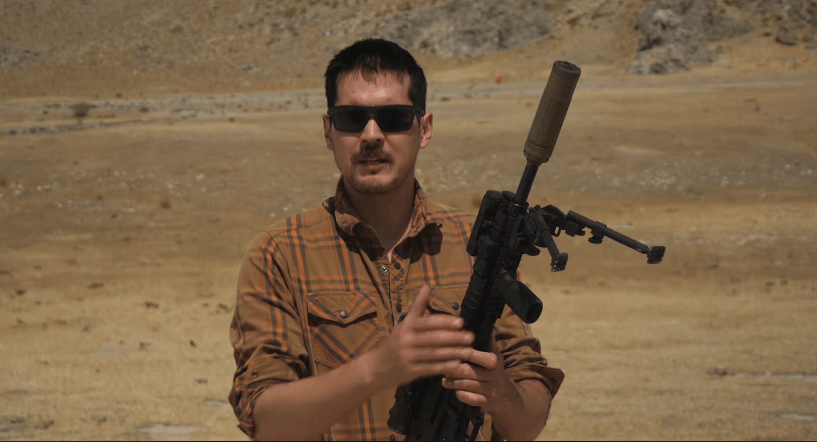 Brass Facts host holding Lima Six