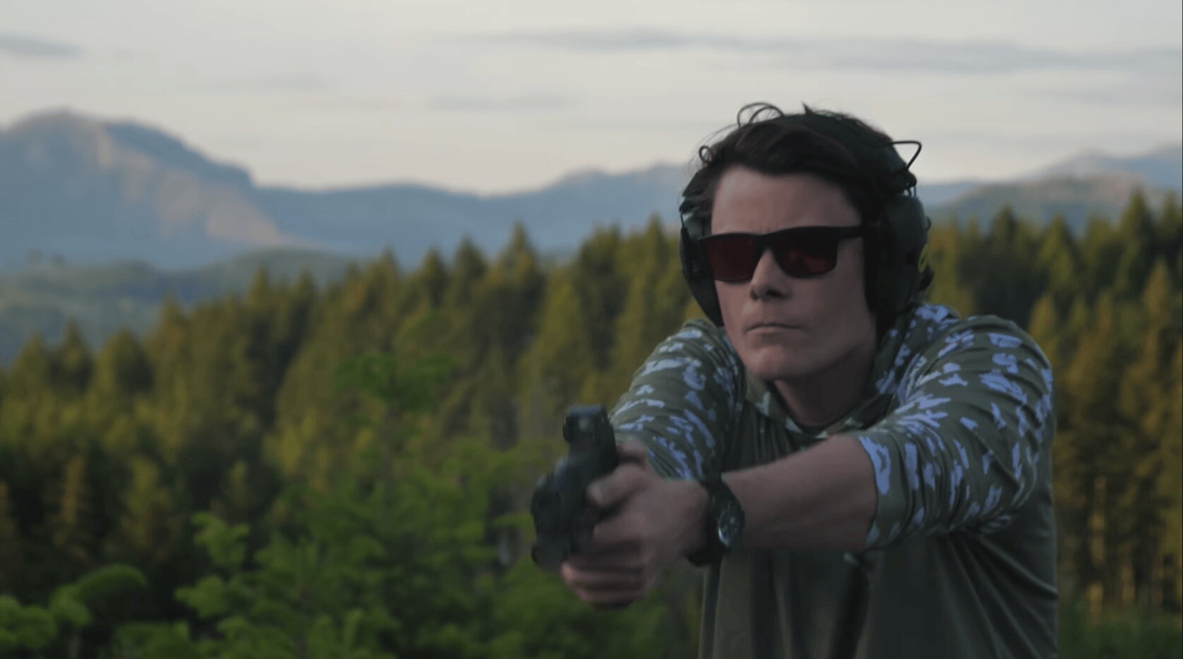 Shooter firing Sig P211 GTO outdoors