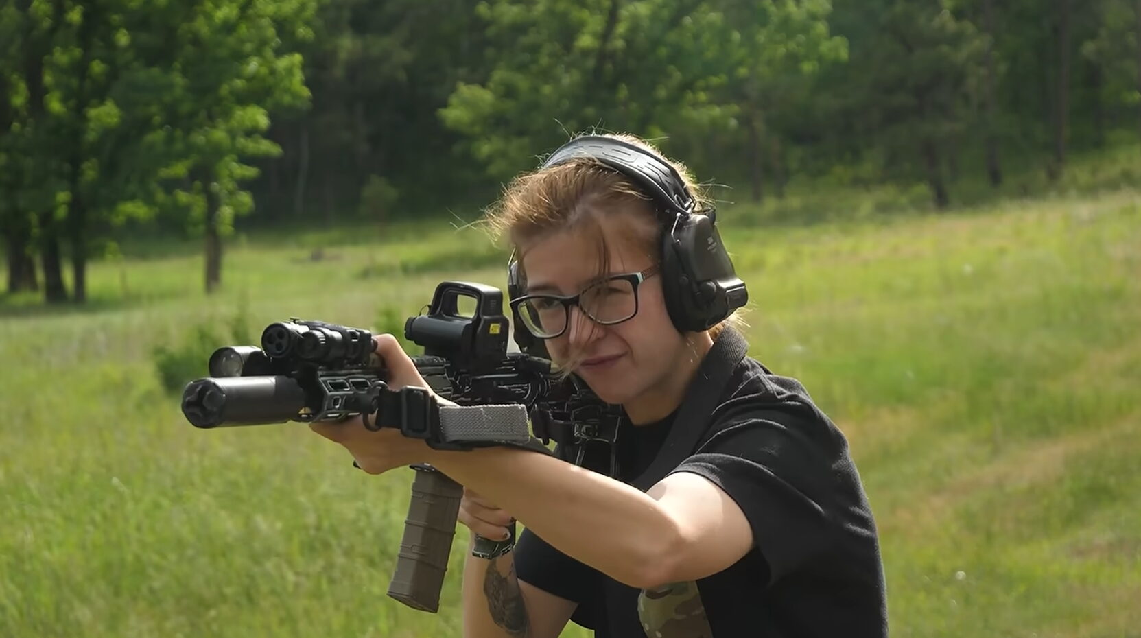 Shooter aiming suppressed short barreled AR